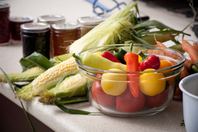 peppers, tomatoes, corn on the cob, and canning jars